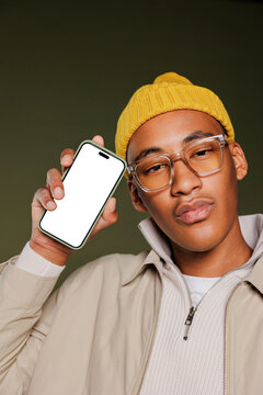 Stylish man showing smartphone with empty screen