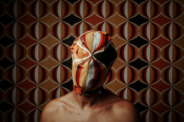 man with his head wrapped with a geometric-patterned paper