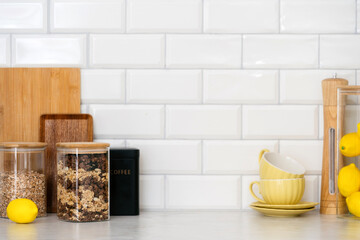 Bright kitchen counter with cereal jars, coffee, and fresh lemons