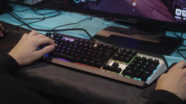 player is playing video game on a keyboard, esport, hand on keyboard, gaming, rgb, High quality 4k footage