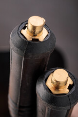 Close-up of cable plugs of an electrode holder and grounding clamp from a welding inverter machine, showing fine details of industrial connections.
