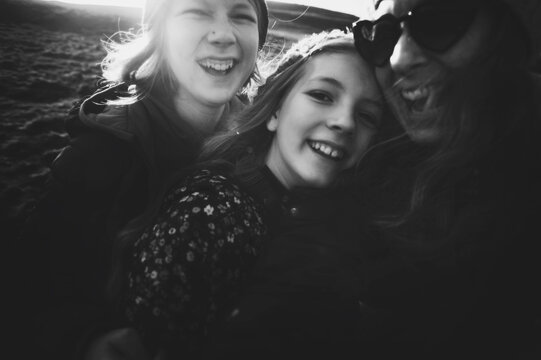 Happy, mum and daughters outdoors selfie