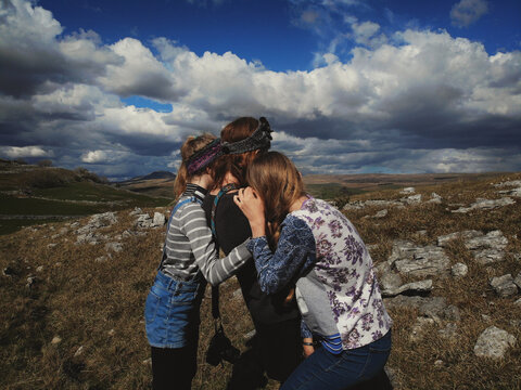 A Mum  and Daughters backs as they look at something