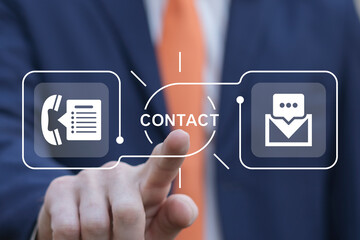 Business person using virtual touch screen presses word: CONTACT. Contact Us Email Marketing...