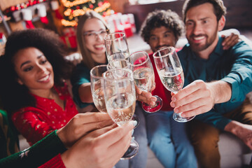 Photo of nice young people celebrate drink champagne enjoy cozy christmas decoration interior house indoors party