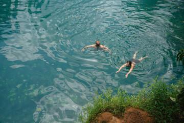 Two People Swimming in Blue Lagoon