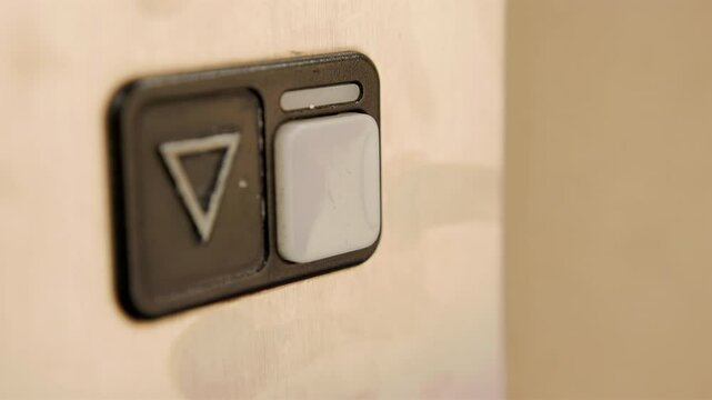 Close up detail of finger pressing elevator signal button to go down 4k
