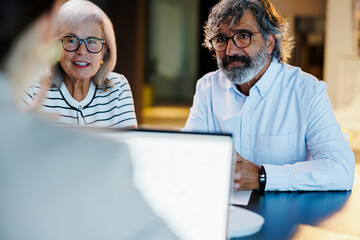 Senior couple meeting financial advisor at office
