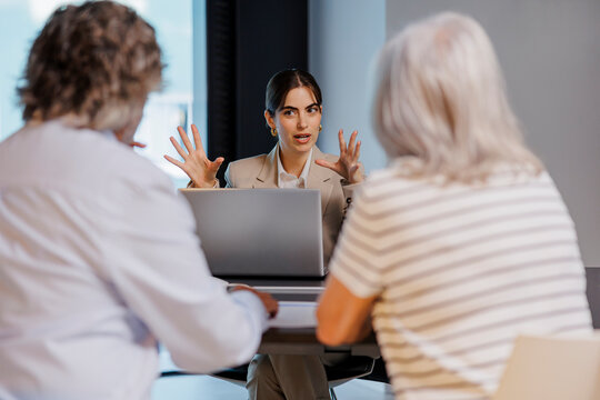 Senior couple meeting financial advisor at office