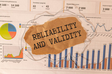 A sign with the inscription Reliability and Validity on the table with office supplies