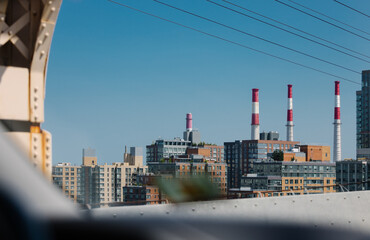 Skyscrapers and industrial smoke stacks in Queens cityscape