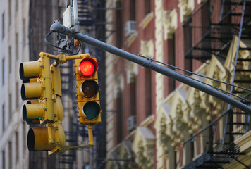 Traffic light with red signal in New York City urban streets