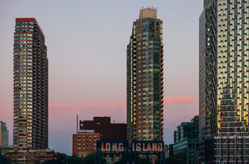 Skyscrapers and iconic Long Island sign in sunset, New York Cityscape