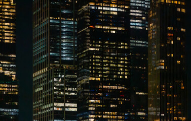 Illuminated New York skyscrapers at night with glowing office windows
