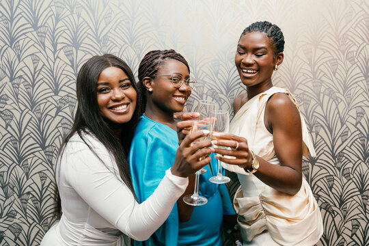 Friends toasting with drinks at a celebration
