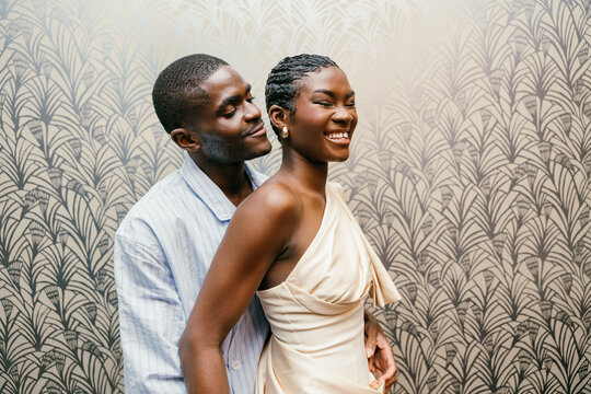 Couple smiling and embracing in an elegant setting in studio