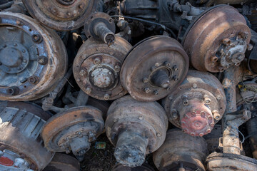 Scrapped truck axles in a scrapyard