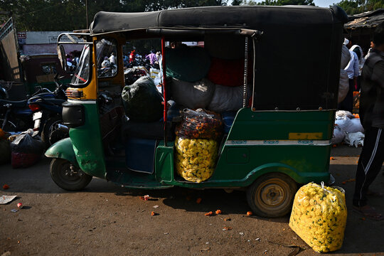 Flowers are loaded into an autorickshaw in a market in India