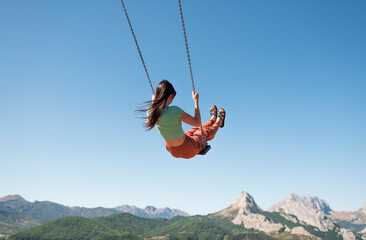 Daydream swinging at scenic mountain landscape