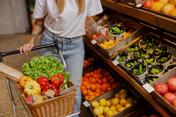 A shopper carefully selects a variety of fresh fruits and vegetables in a vibrant and lively market setting