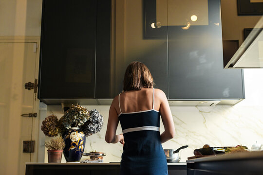Female cook working on a recipe in the kitchen