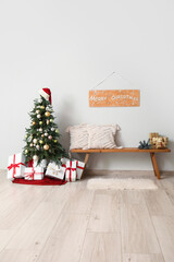 Interior of room with beautiful decorated Christmas tree and gifts