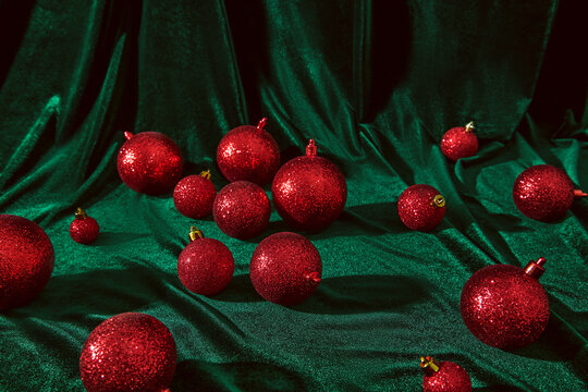 Festive Red Christmas Ornaments on Green Fabric Background