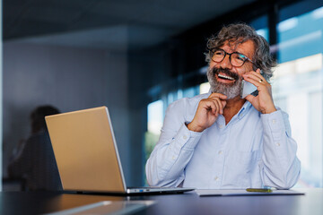 Financial advisor talking on phone and smiling at work