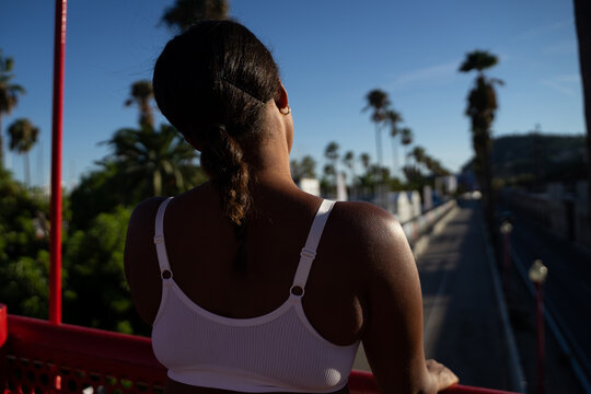 Woman In Sport Clothes Standing On Bridge