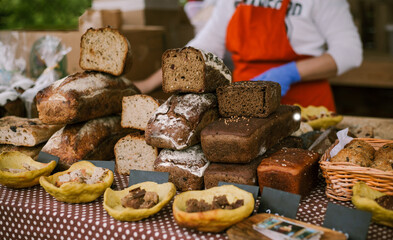 A stall at a food festival with different types of fresh bread.