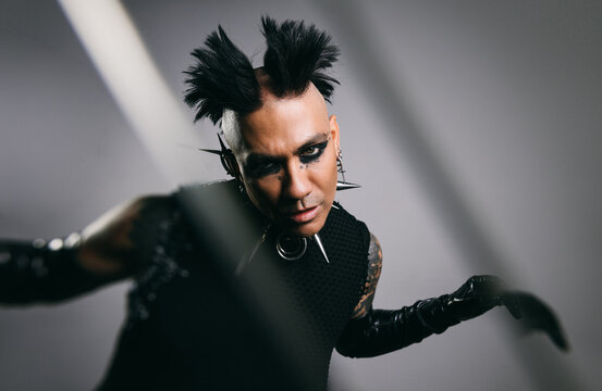 Edgy punk man with mohawk and spikes in futuristic fashion