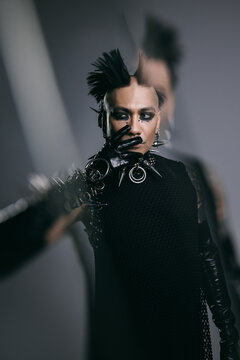 Edgy man with punk hairstyle and dark makeup, fashion statement