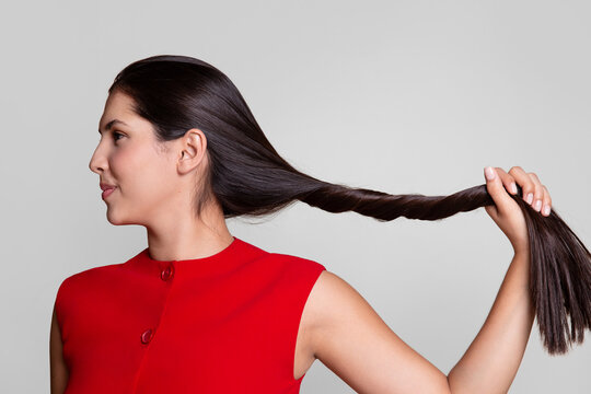 Woman holding her long dark shiny hair