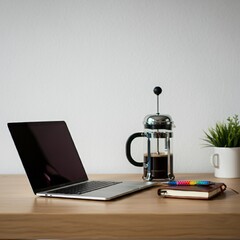 Modern workspace with a laptop, coffee, and notebook on a clean desk