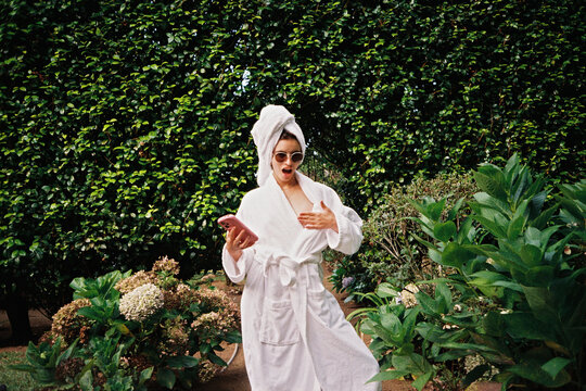 Surprised woman with bathrobe UGC film portrait