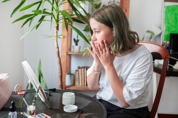 Girl Teenager puts on makeup 
