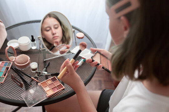 Girl Teenager puts on makeup 