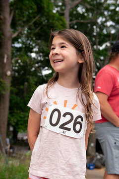 Portrait of happy child competing in running race