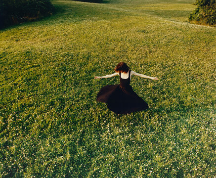 Woman Dancing Freely in a Blooming Meadow