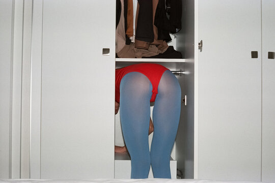 Humorous Scene of Woman in Wardrobe with Colorful Tights
