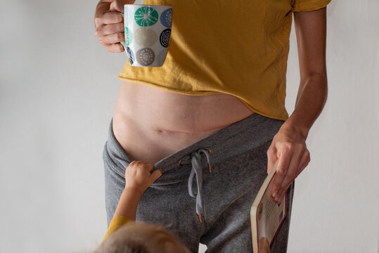 Mother with a cesarean section scar with a baby
