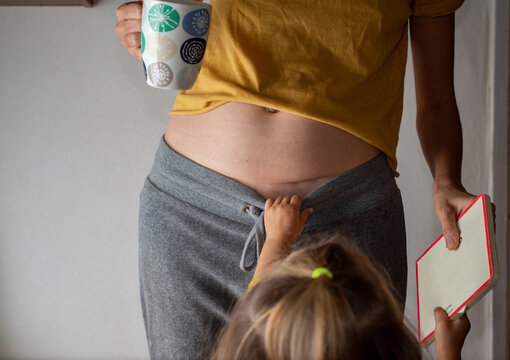 Mother with a cesarean section scar with a baby