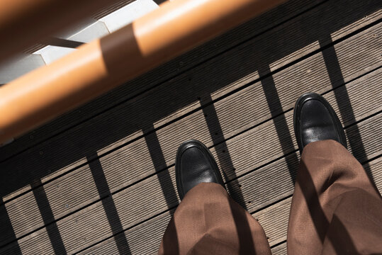 Man in the diagonal lines on the wooden floor