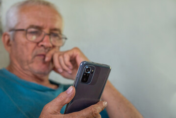 Elderly man looking at smartphone