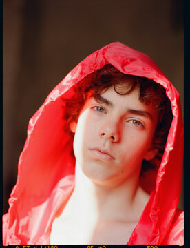 Youth Wears a Bright Red Hooded Cloak