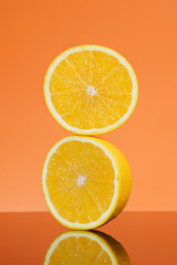 Orange fruit. Slices with reflective isolated on orange background