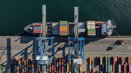 Aerial View of Crane Loading Shipping Containers at Port