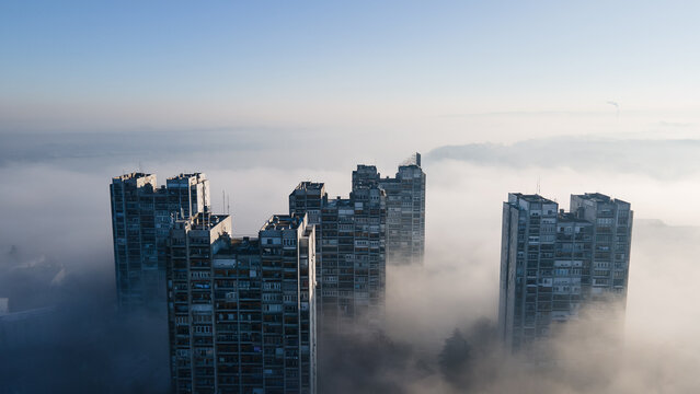 Fog-Covered Cityscape: Buildings Rising from the Mist
