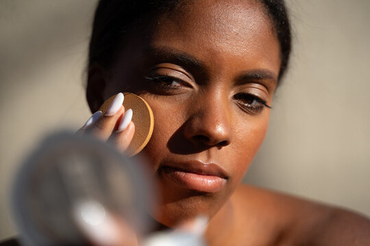 Dominican Woman Applying Powder