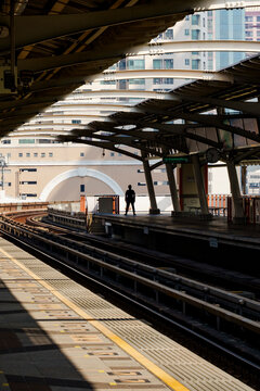 A man standing on the Skytrain platform